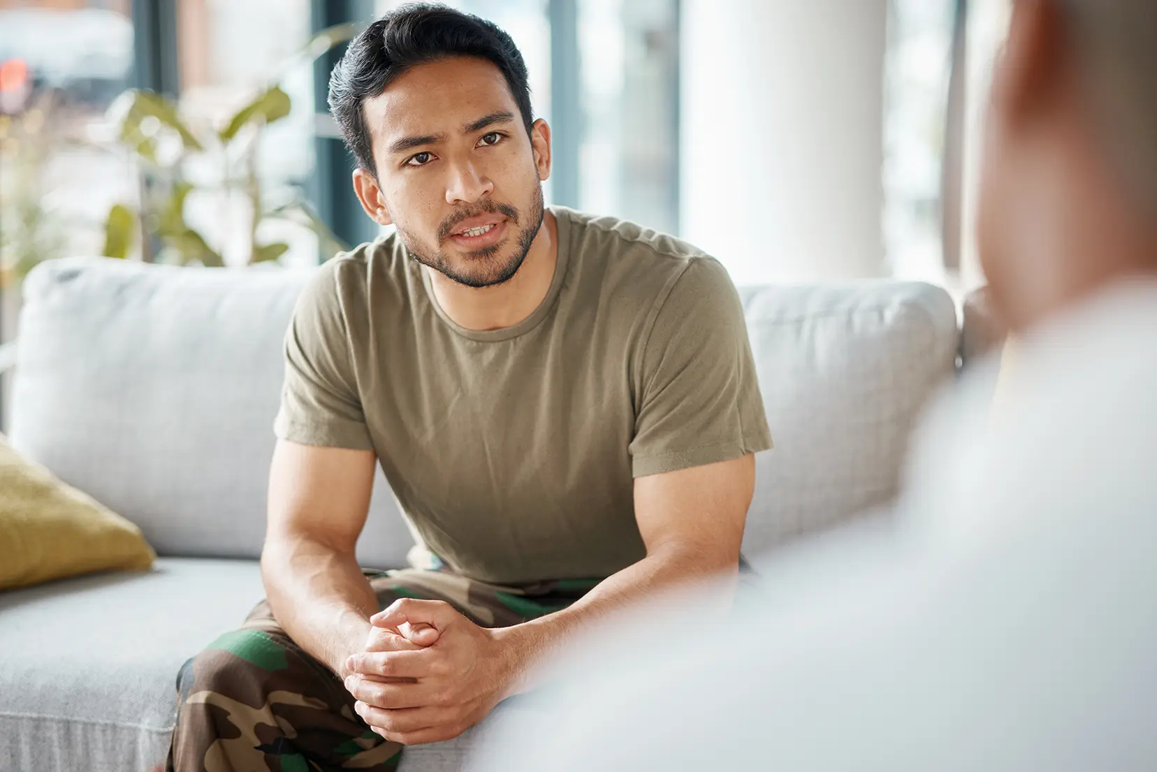 Hispanic man speaking to a therapist during a session